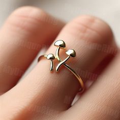 *Free engravings up to 20 characters* Delve into the enchanting world of nature with this minimalist mushroom ring! 🌟 It's a charming adornment for your finger or a splendid gift for anyone fascinated by the mystical beauty of mushrooms. 🍄💕 Celebrate the organic allure of nature or simply enjoy a unique piece of jewelry, this mushroom ring is a touch of natural wonder, ready to accompany you on everyday adventures. Great for stacking or on its own band width: 1.5mm Feel free to message us for customization! We can usually make minor alterations at no added charge. Covered by full warranty for 3 months after purchase - including resize. -------------- Thanks for shopping at ShineSwap! We are a manufacturer of fine jewelry items. We sell directly to the public so you can avoid paying for Minimalist Mushroom, Sketch Jewelry, Jewelry Mushroom, Mushroom Ring, Mushroom Jewelry, Organic Jewelry, Mushroom Design, Everyday Adventures, Cute Rings