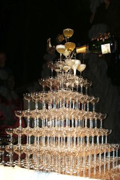 there is a very tall tower made out of wine glasses