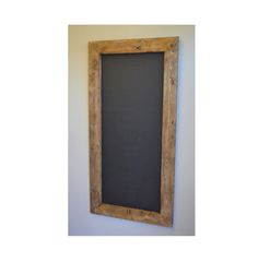 a chalkboard mounted to the wall with a wooden frame on it's side