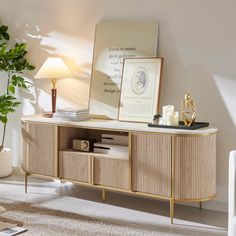 a living room with a couch, table and lamp on it's sideboard