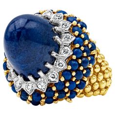 This vintage high dome cocktail ring showcasing a lapis lazuli blue cabochon the center stone, encrusted with 16 brilliant round shape diamonds weighing 0.50 carats total. Set in a beautiful dome with blue cabochon in 18k yellow gold. Size 7.5 US. Ruby Diamond Pendant, Cocktail Vintage, Lapis Lazuli Blue, Diamond Bows, Ringe Gold, Bling Rings, Jewelry Business, Drop Pendant, Yellow Diamond