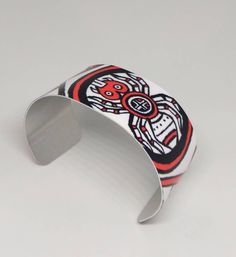 "This lightweight, adjustable aluminum cuff features artwork by Cherokee Nation artist, MaryBeth Timothy. The title of this image is \"SouthEast Spiders\". Although the art is done in a contemporary style, the designs on this cuff are actually a variety of ancient mound symbols found in or around the native burial mounds (Moundville, AL; Spiro, Ok; Etowah, GA; etc.). This cuff features the spider motif. The cuffs are easily squeezed and pulled apart to adjust to most adult sized wrists. Dimensio Southeast Native Americans, Bookmark Printing, Metal Bookmarks, Cuff Bracelet, Ceramic Tiles, Native American, Contemporary Style, Cuff Bracelets, Gifts For Friends