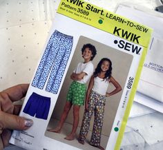 a person holding up a sewing pattern for children's pajama pants and shorts