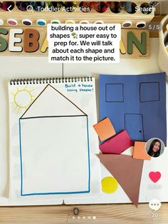 an open notebook with paper cutouts and pictures on the cover, next to some crafting supplies