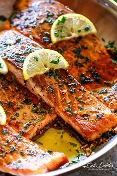 grilled salmon with lemons and herbs in a pan