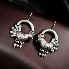 Add a touch of elegance and charm to your ensemble with these Adorable Oxidized Bird Earrings. Perfectly blending traditional craftsmanship with contemporary aesthetics, these silver look-alike hook style earrings are designed to make a statement. Featuring intricate bird motifs and a high-quality oxidized finish, they are the ideal accessory for any occasion.

Charming Bird Motif Design
The delicate bird design symbolizes freedom, grace, and beauty, adding a meaningful touch to your jewelry collection. These Oxidized Bird Earrings showcase exceptional artistry, with every detail meticulously crafted to create a stunning visual appeal. Bird Motif, Bird Earrings, Black Polish, Oxidised Jewellery, Motif Design, Earring Crafts, Bird Design, Style Earrings, Look Alike