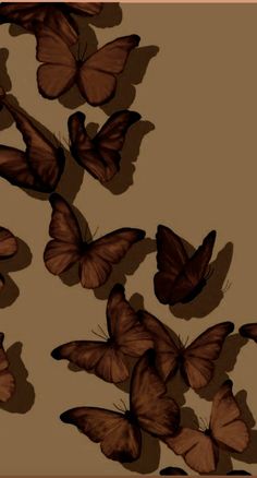 a group of butterflies flying in the air over a brown background with black outlines