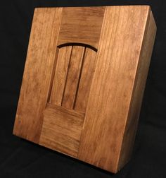 a wooden box with a chair in the middle on a black cloth covered tablecloth