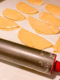 dough being rolled out on a baking sheet