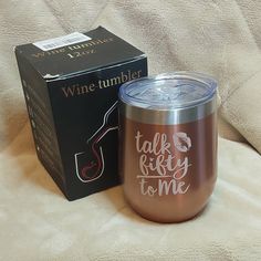 a wine tumbler sitting on top of a couch next to a box with the words talk right to me written on it