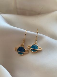 Size: 1.2x1.6x0.2cm  Weight: 30g (pendant only) Introducing the 'Midnight Blue Planet' earrings by J&K Jewellery. If you love all things space then these are the perfect earrings for you! Our earrings are all hypoallergenic that comes with a rubber back and each space pendants are made of high quality alloy. If you love all things planets, moon and stars then these are the one for you! These unique earrings will grasp everyone's eye. The space earrings are perfect for gift for those space lovers Space-themed Gold Jewelry Gift, Space-themed Drop Earrings As Gift, Blue Tarnish-resistant Earrings For Gift, Gold Space-themed Earrings Gift, Space-themed Gold Earrings Gift, Space-themed Dangle Jewelry Gift, Blue Pendant Earrings For Gift, Blue Celestial Hypoallergenic Jewelry, Earrings Space