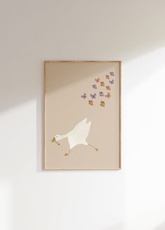 a white bird flying in the air with butterflies coming out of it