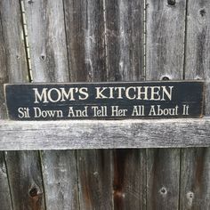 a wooden sign that says mom's kitchen sit down and tell her all about it