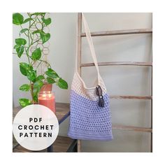 a crocheted bag sitting next to a potted plant