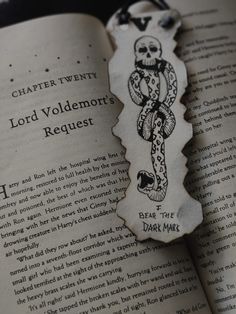 a bookmark with an image of a cross on it and the words lord voldemon's request