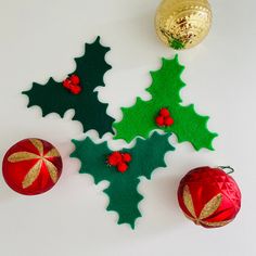 three christmas ornaments on a white surface