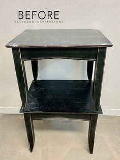 a black end table sitting on top of a white floor