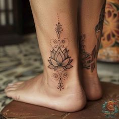 a woman's foot with a lotus tattoo on it