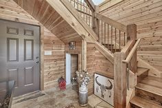 a wooden staircase leading up to a door