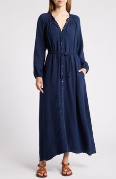 Move stylishly from work to weekend in this gauzy cotton maxi designed with a defining rope belt and feathery fringed trim. Front button closure Split neck Long sleeves Side-seam pockets Removable tie belt 100% cotton Machine wash, line dry Made in the USA Cotton Belted Maxi Dress, Blue Belted Maxi Dress, Indigo Long Sleeve Cotton Dress, Blue A-line Cotton Maxi Dress, Casual Long-sleeved Cotton Gauze Dress, Indigo Cotton V-neck Dress, Gauze Maxi Dress, Maxi Design, Blue Rayon V-neck Maxi Dress