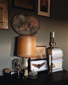 a lamp and some pictures on a table