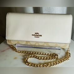 Beautiful Cream And Tan Leather Coach. Has Many Card Slots And Zippered Pouches Comes With Dust Bag And Shoulder Chain Strap.Nwot Coach Wallets With Chain Strap For Everyday Use, Coach Wallet On Chain For Everyday Use, Luxury White Wallet On Chain, Coach Crossbody Wallet With Detachable Strap, Coach Rectangular Chain Wallet With Detachable Strap, Coach Crossbody Wallet For Travel, Classic Coach Wallet With Detachable Strap, Coach Leather Wallet On Chain For Everyday Use, Coach Wallet On Chain With Detachable Strap