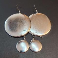 I am starting to make large disc earrings in silver color too, per popular request.  ☺ These earrings are made out of recycled steel discs with surgical steel ear wires. The domed discs have a brushed finish. Make a statement with these Large Domed Circle Charm Earrings.  Featuring thin, lightweight domed circles rustic brushed-scratched appearance, these disc earrings are the perfect addition to any boho or vintage-inspired look.  The steel ear wires make them easy to wear all day long, while t Round Dangle Earrings, Disc Earrings, Large Earrings, Single Earring, Minimalist Earrings, Charm Earrings, Ear Wires, Silver Color, Circles