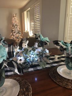 the table is set for christmas with green and white decorations