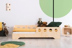 a child's bedroom with green and yellow decor, including a bed made out of plywood