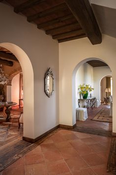 an archway leads to the living room and dining area in this home with tile flooring