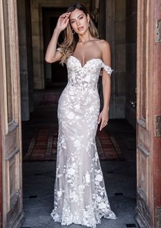 a woman in a wedding dress posing for the camera