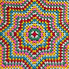 a colorful crocheted square is shown in red, yellow and blue