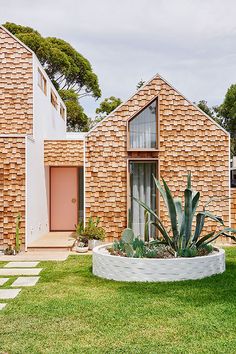 the house is made out of bricks and has a circular planter