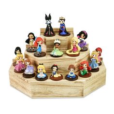 there are many little princess figurines on this wooden display stand with the price tag