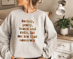 Turkey Gravy Beans And Rolls Let Me See That Casserole Sweatshirt, Thanksgiving Sweater, Thanksgiving Shirt, Fall Sweatshirt, Fall Shirt, Thanksgiving Crewneck Sweater -Our shirts are made to order specially for you. Because of this reason we don't accept returns or exchanges. Please check our color and size charts before you place your order. If you have any questions please send us a message to clarify sizing or colors. ###Product Information### * Sweatshirt: 50% Cotton 50% Polyester * T-shirt Thanksgiving Sweaters Cheap, Thanksgiving Sweater, Disney Christmas Shirts, Funny Christmas Sweaters, Winter Sweatshirt, Hoodie Material, Sweatshirt Christmas, Embroidered Hoodie, Embroidered Tshirt