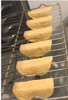 six pieces of bread sitting on top of a metal rack