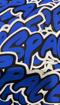 blue and black graffiti on the side of a skateboarder's board,