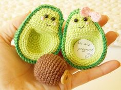 two crocheted peas are sitting in the palm of someone's hand