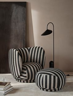 a black and white striped chair sitting next to a lamp