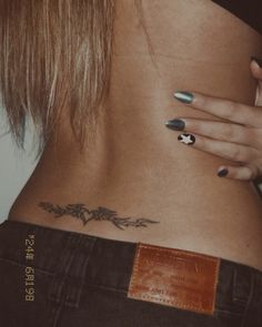 a woman's lower back with tattoos on her left side and the bottom part of her stomach