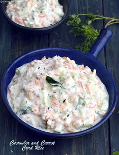 two blue bowls filled with coleslaw on top of a wooden table and garnished with parsley