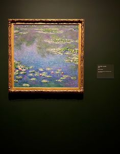 a painting hanging on the wall in a museum