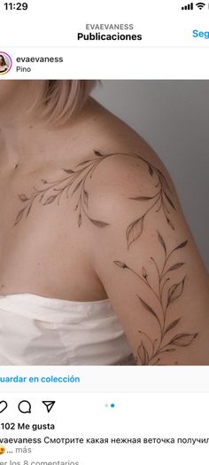 the back of a woman's shoulder with leaves on it