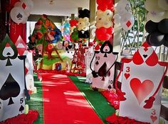 a red carpeted hallway with lots of cards and balloons on the walls, along with decorations