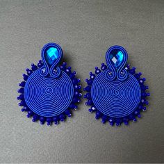 Description: Round Royal Blue Statement Soutache Earrings These Items Are Individually Made With Love By Me. Details: Handmade Item These Trendy Soutache Earrings Are 100% Handmade And Have One-Of-A-Kind Designs. Color: Blue Material: Viscose Cords & Beads Metal: Stainless Steal Dimensions: 2.1" Style: Elegant/ Boho Chic / Stylish/ Art Deco Care Instructions: Store Out Of Direct Sunlight And Keep Away From Water. It Is Not Recommended To Wear These Earrings In Or Around Water. Glam Earrings, Stylish Earrings, Stylish Art, Soutache Earrings, Stainless Steal, Soutache Jewelry, Stylish Earring, Trendy Earrings, Working Woman