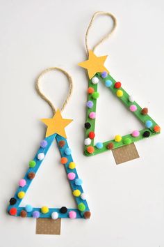 two christmas tree ornaments made out of construction paper and colored pom - poms