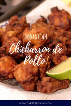 a plate full of fried chicken with a lime wedge next to it and the words dominicani chicharro de pollo