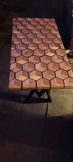 a wooden table sitting on top of a sidewalk