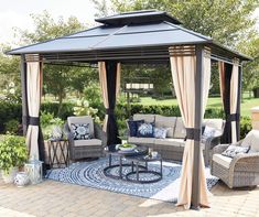 a gazebo sitting on top of a patio covered in furniture