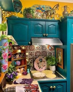 a kitchen with blue cabinets and green cupboards